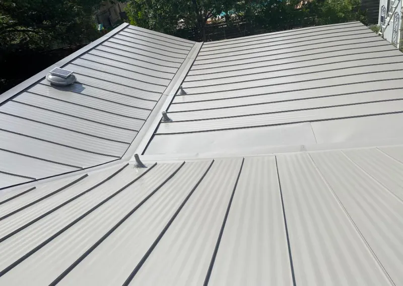 Solar attic fan installed on a metal roof for Roof Ventilation in Wesley Hills